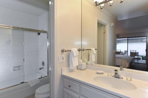 a bathroom with a sink and a toilet and a mirror at 657 Cottages at Silverado residence in Napa