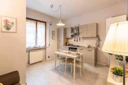 a kitchen with a table and a dining room at La Casina di Nello in Montepulciano