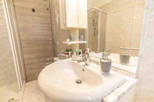 a bathroom with a white sink and a mirror at La Casina di Nello in Montepulciano