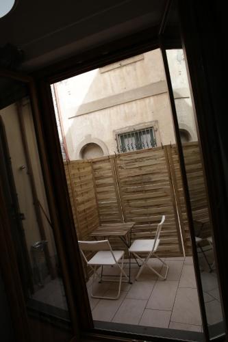 a view of a table and chairs from a window at LA RAJA in Scilla