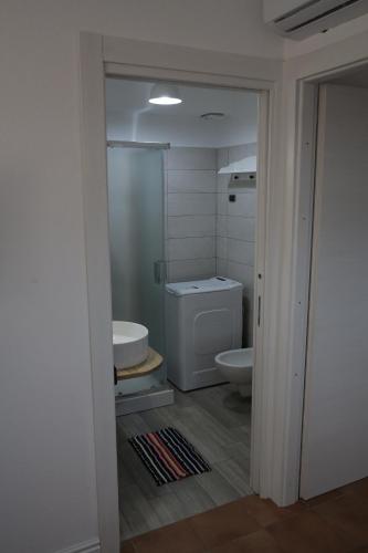 a bathroom with a toilet and a sink at LA RAJA in Scilla