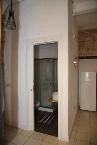 a bathroom with a toilet and a glass shower at LA RAJA in Scilla