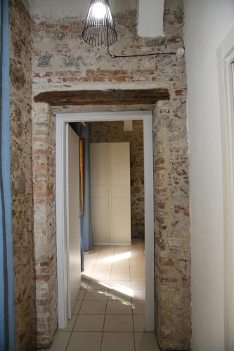 a hallway with a brick wall and a light fixture at LA RAJA in Scilla