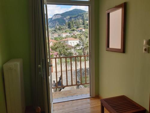 a door to a balcony with a view of a mountain at Christina Guest House in Mystras