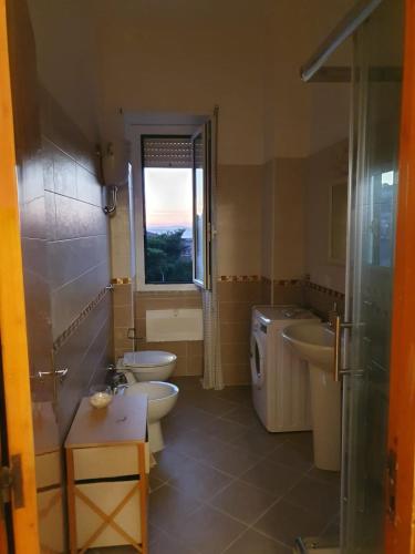 a bathroom with two sinks and two toilets at maison jolie - Agropoli da vivere- in Agropoli
