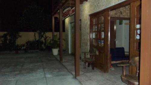 a hallway of a building at night at Pousada da Lenna in Rio das Ostras