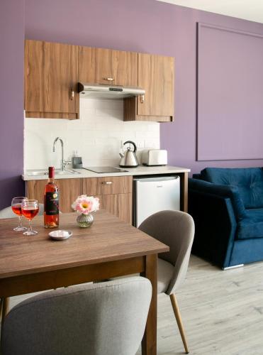a kitchen with a wooden table with two glasses of wine at Archontiko Kiverniti in Pano Lefkara