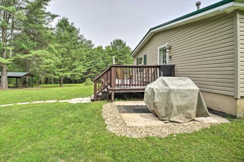 a house with a porch and a wooden deck with a tent at Deck, Fire Pit and Yard Mountain Escape! in Benezette