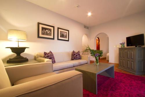 a living room with a couch and a table at Alta Las Palomas Hotel in San José