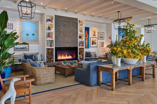 a living room filled with furniture and a fireplace at The Seabird Ocean Resort & Spa, Part of Destination Hotel by Hyatt in Oceanside