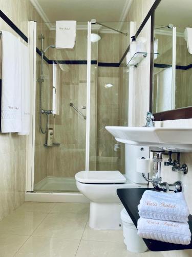 a bathroom with a sink and a toilet and a shower at Hostal Casa Isabel in Portonovo