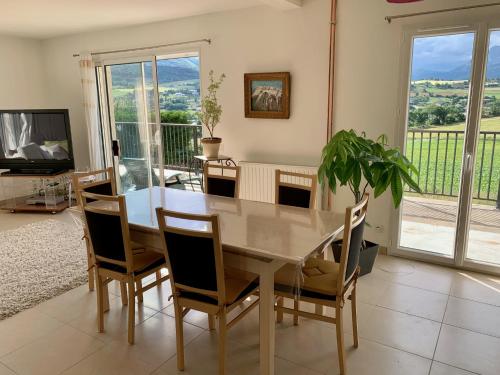 une salle à manger avec une table et des chaises dans l'établissement Grande maison vue sur lac à Pelleautier très calme, à Pelleautier
