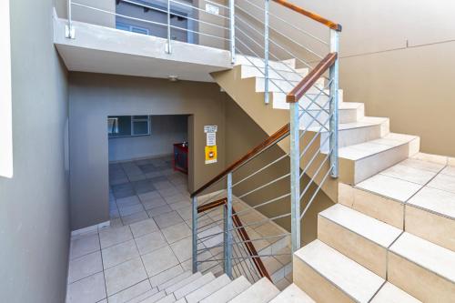 a spiral staircase in a building with a hallway at Stunning Knysna central Apartment in Knysna