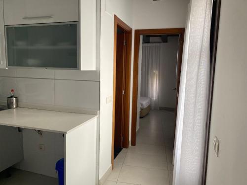 a kitchen with a white counter top and a hallway at Plaza Negrito Apartments in Valencia