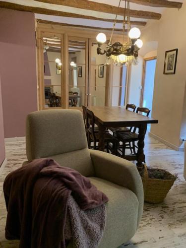 a living room with a chair and a table at La Caseta del Priorat in Porrera