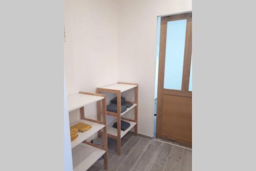a room with white shelves and a door at Gîte des Rigoles 2 in Le Faulq