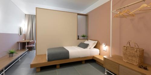 a hotel room with a bed and a desk and sidx sidx sidx sidx at Mandraki Village Boutique Hotel in Koukounaries