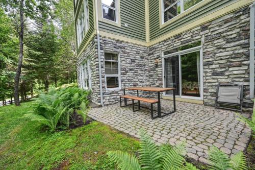a picnic table sitting outside of a house at Tremblant Les Eaux by Rendez-Vous Mont-Tremblant in Mont-Tremblant