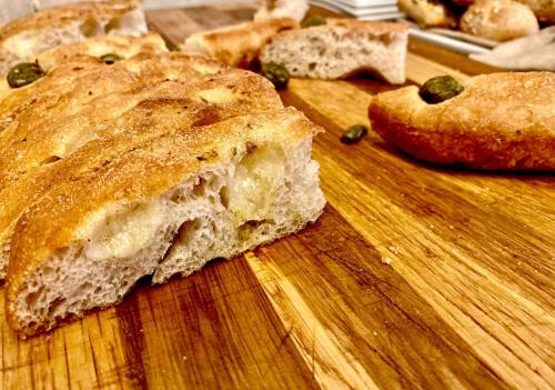 a piece of bread sitting on a wooden cutting board at Antica Locanda Del Villoresi in Nerviano