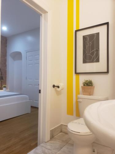 a bathroom with a toilet and a sink and a tub at Hotel and the City, Empire State Building in New York
