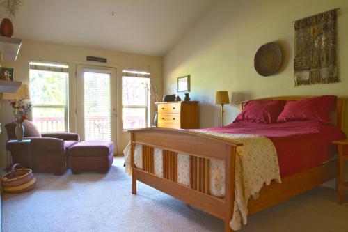 a bedroom with a bed with a red comforter at Widgi Creek #22 condo in Bend