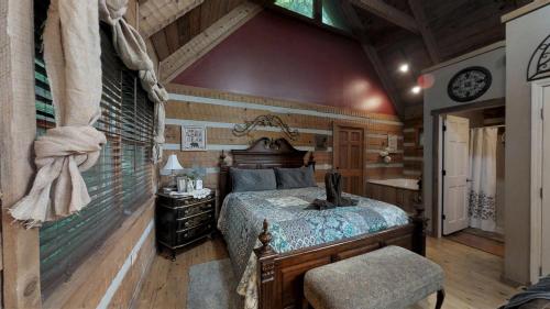 a bedroom with a bed and a desk and a chair at Blessed Nest Cabin in Townsend