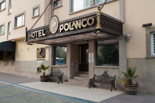 a restaurant with two benches in front of a building at Hotel Polanco in Mexico City