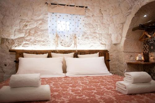 Ein Bett oder Betten in einem Zimmer der Unterkunft LiberaMente - Trulli & Quiete