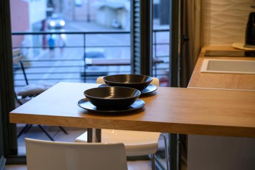 two bowls on a table with a view of a street at Luxury Suites by Panagiota in Preveza