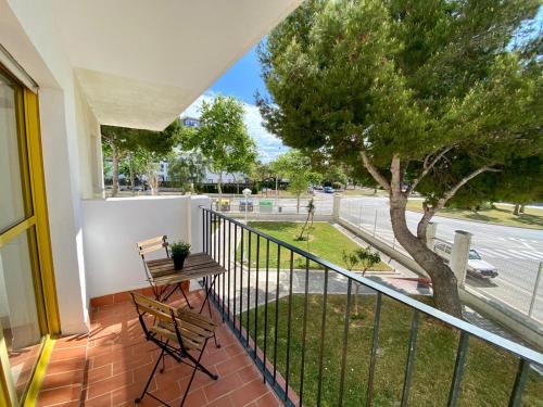a balcony with a table and chairs and a tree at ESTUDIO BLEGAMAR TERRAZA - Playa, WiFi y Aparcamiento in El Puerto de Santa María