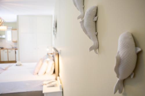 a bedroom with two seahorses on the wall at Likio Studios in Batsi