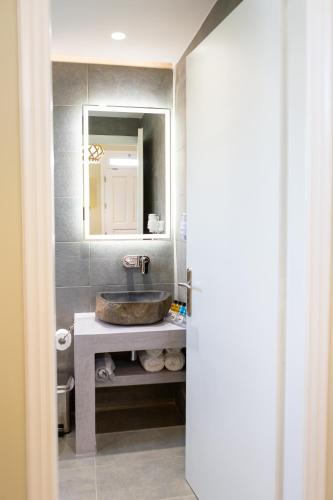 a bathroom with a sink and a mirror at Likio Studios in Batsi
