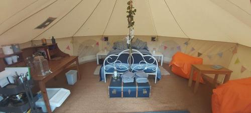 a room with a bed in a tent at Garden County Glamping in Newtown Mount Kennedy