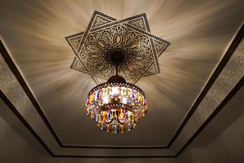 a large chandelier hanging from a ceiling at Riad Dar Yassine in Marrakech