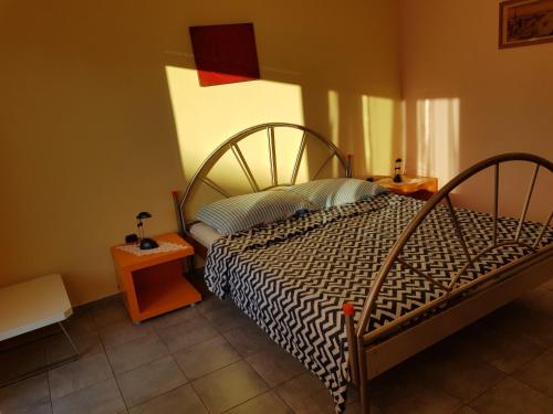 a bedroom with a bed with a black and white comforter at Hana in Umag