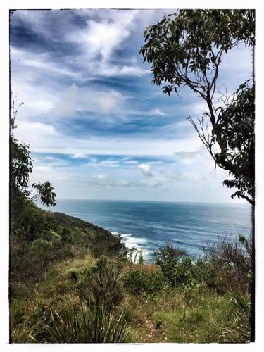 a view of the ocean from the top of a hill at Bay House Motel in Bateau Bay