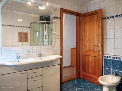 a bathroom with a sink and a toilet at Moai Home Apartman Sárvár in Sárvár