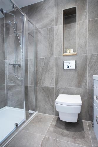 a bathroom with a toilet and a glass shower at Leggetts Lane in Whitstable