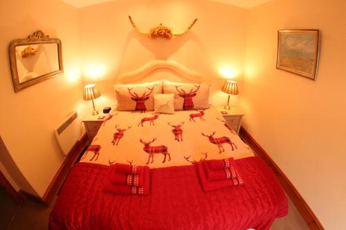 a bedroom with a bed with deer on it at Red Stag Apartment in Nairn