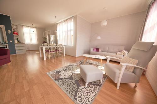 a living room with a couch and a table at Rose Apartment in Haapsalu