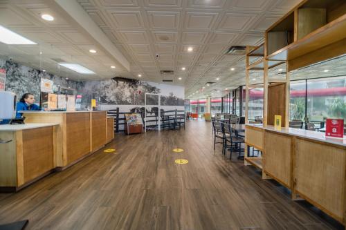 a large office with wooden counters and tables and chairs at Equus Inn I75 in Ocala