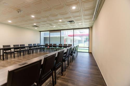a conference room with a long table and chairs at Equus Inn I75 in Ocala