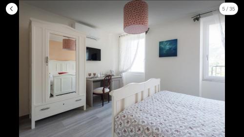a bedroom with a bed and a dresser and a desk at La Linea D'Acqua in Manarola