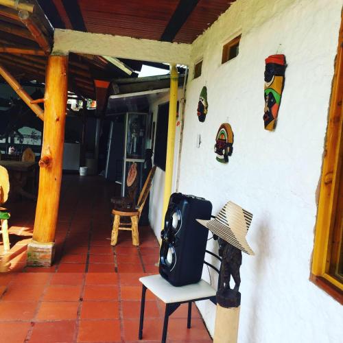 a hat is sitting on a chair on a porch at CABAÑA LOS NOGALES in San Agustín