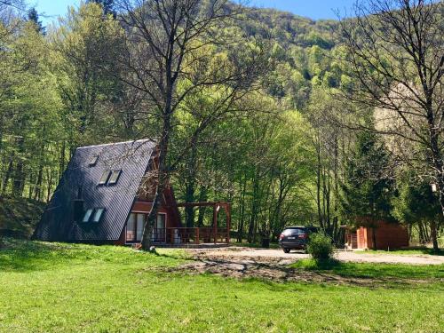 a barn with a car parked in front of it at Zen House in Brod na Kupi