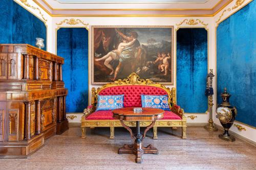 a room with a couch and a painting on the wall at Historical Villa GINA with Magic Lake View in Dizzasco