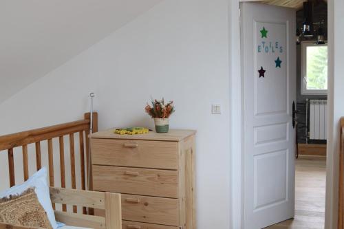 a room with a dresser and a door with stars on the wall at Chambres d'hôtes "HOR DAGO" près de la gare d'Hendaye avec le petit-déjeuner in Hendaye
