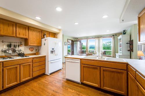 a kitchen with wooden cabinets and a white refrigerator at Valley Green in Enumclaw