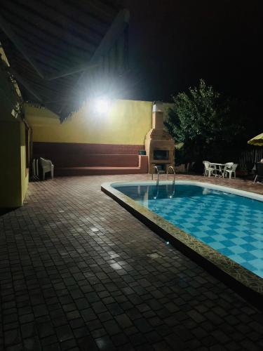 a swimming pool at night with a light above it at Hotel RichI G A in Tbilisi City
