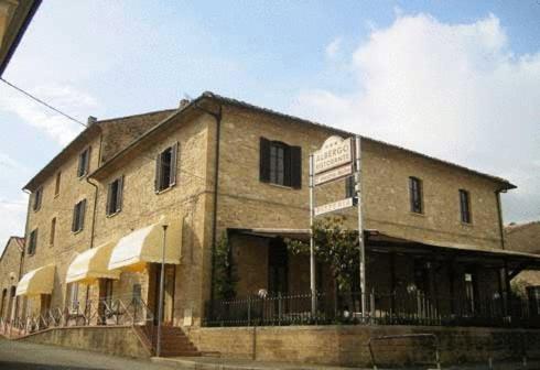 a building on the side of a street with a street sign at Il Vecchio Mulino in Volterra